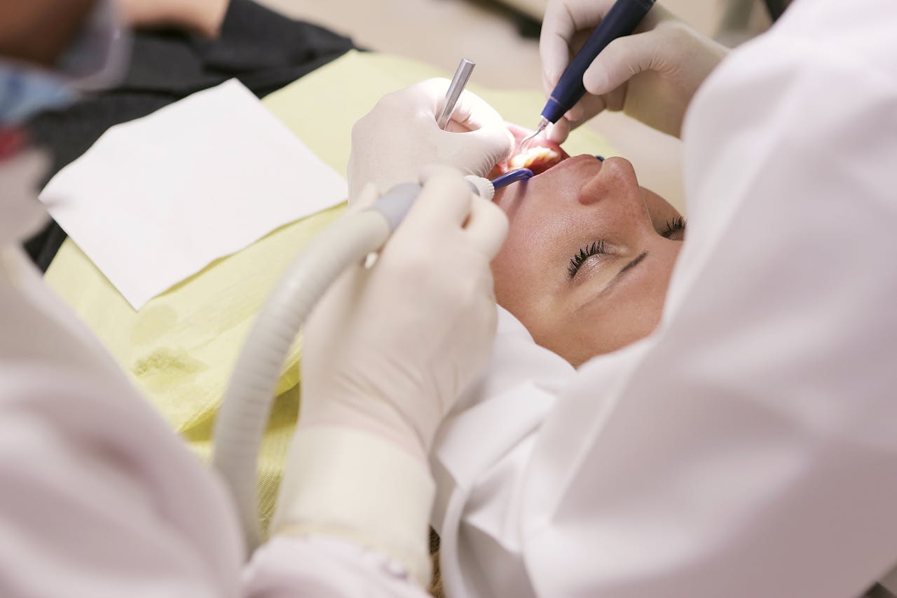 Dentists in white coats treating patient and discussing teeth implants cost in Melbourne